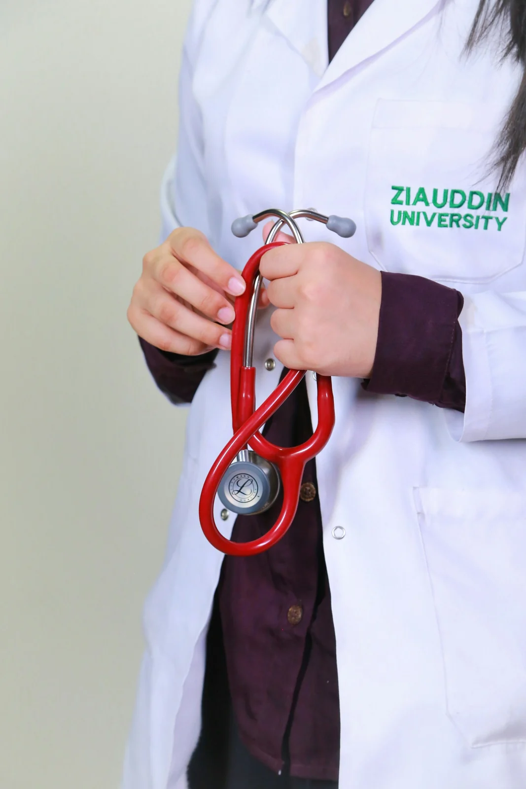 Close-up of a medical professional holding a stethoscope in Karachi